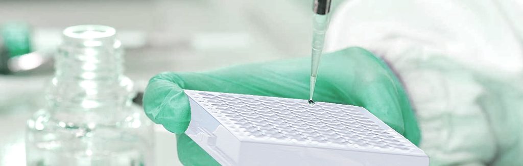 Pipette working over a multiwell plate in a laboratory
